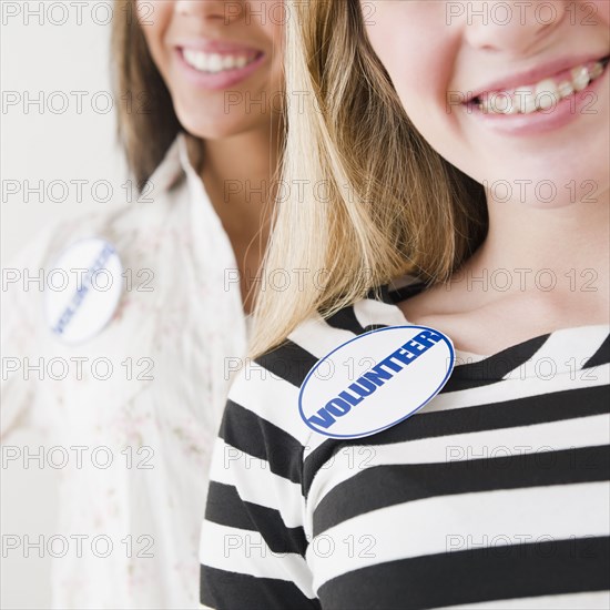 Teenage girls wearing volunteer badges