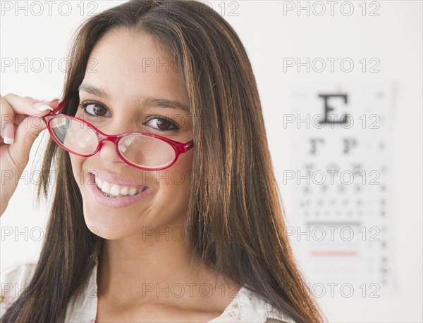Hispanic teenage girl having eye exam