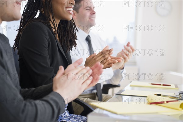 Business people clapping in meeting