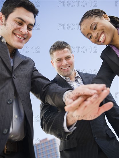 Business people clasping hands together