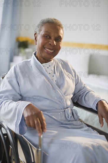 Black woman sitting in wheelchair in  hospital