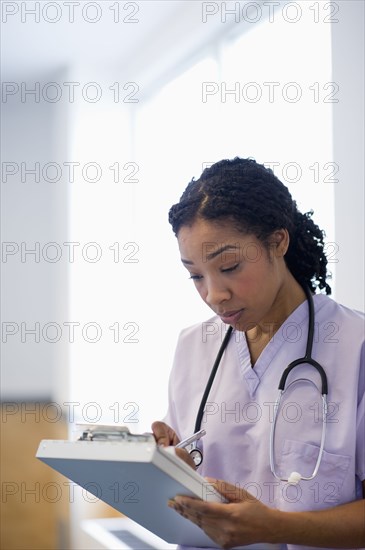 Nurse writing in medical record in hospital