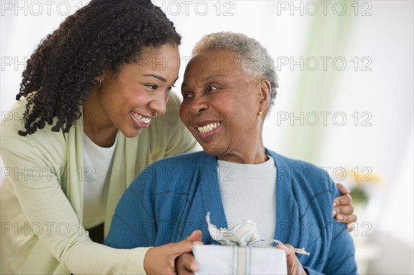 Daughter giving mother birthday gift