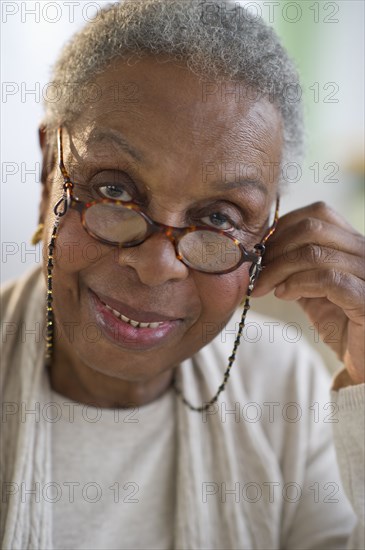 Black woman adjusting eyeglasses