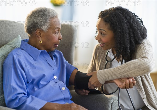 Nurse taking woman's blood pressure