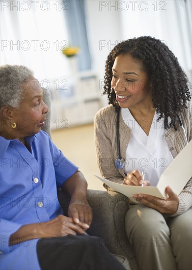 Nurse giving woman checkup