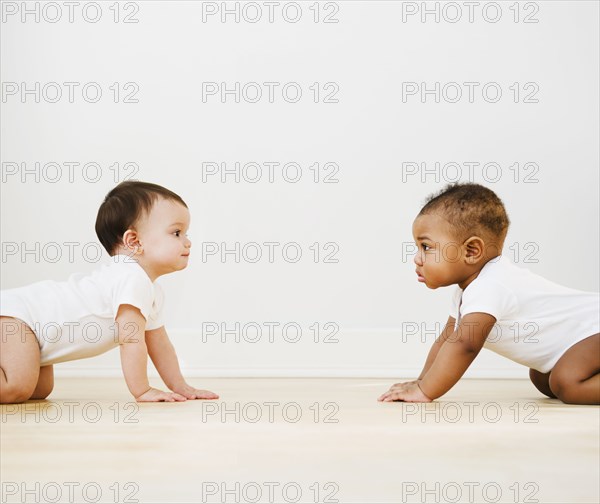 Babies crawling on floor