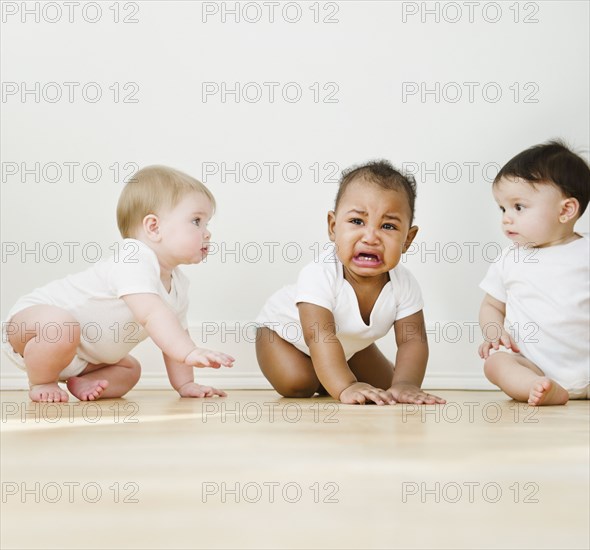 Babies watching crying friend