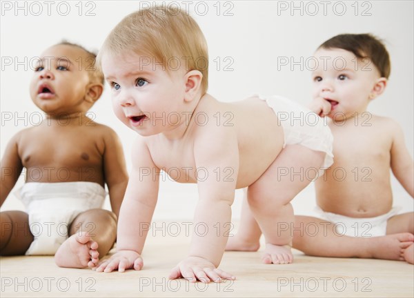 Babies playing together on floor