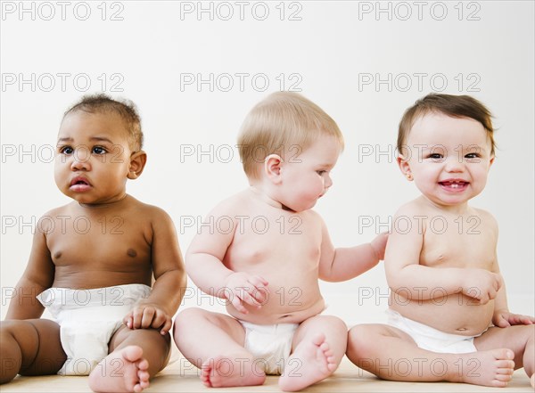 Babies sitting together on floor