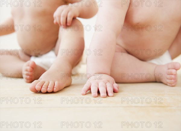 Babies sitting together on floor