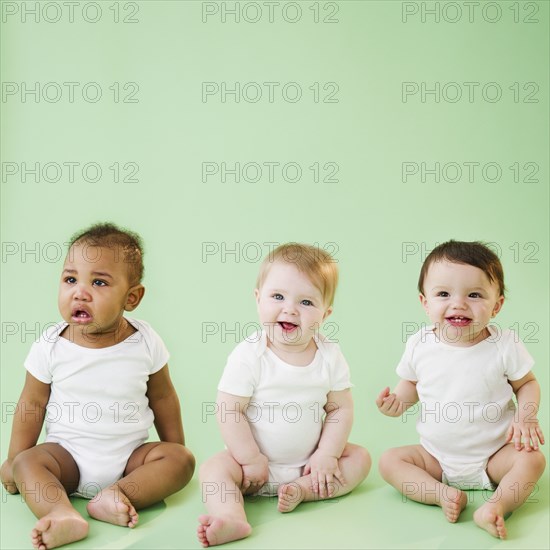 Babies sitting together on floor