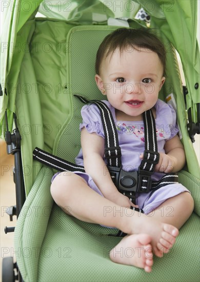 Mixed race baby sitting in stroller