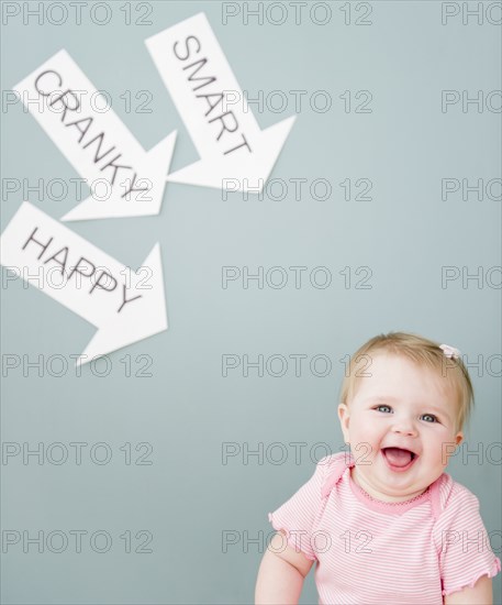 Caucasian baby near arrows reading cranky