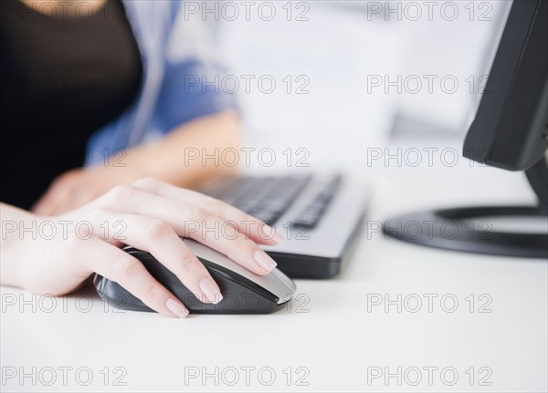 Close up of Korean woman using computer mouse