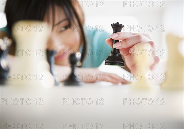 Korean woman playing chess