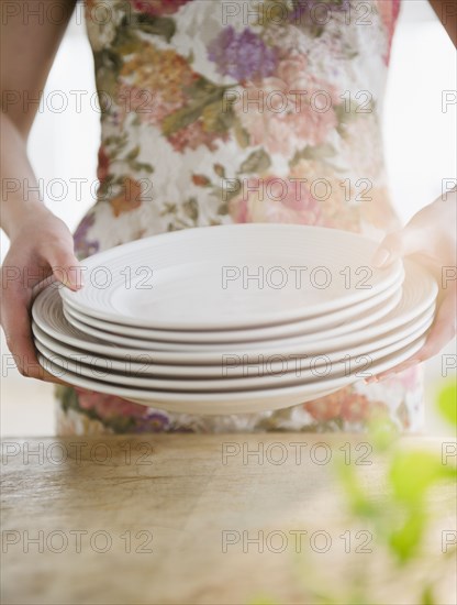 Korean woman carrying plates