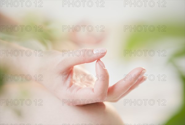 Close up of Korean woman's hands making yoga gesture