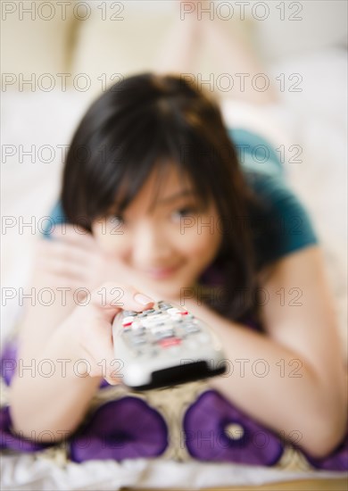 Korean woman holding remote control