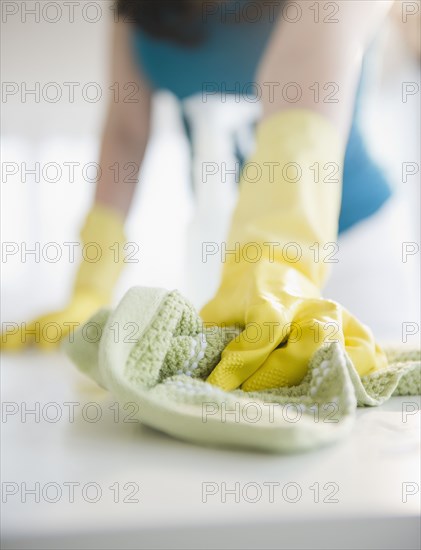 Close up of Korean woman wiping counter