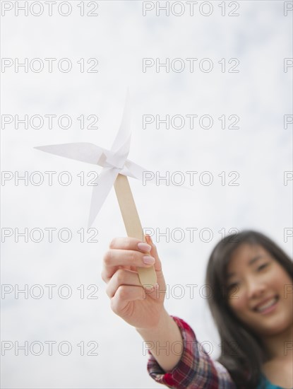 Korean woman holding paper pinwheel
