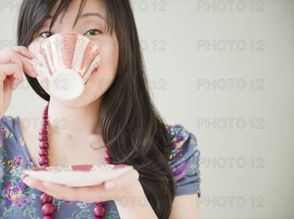 Elegant Korean woman drinking coffee