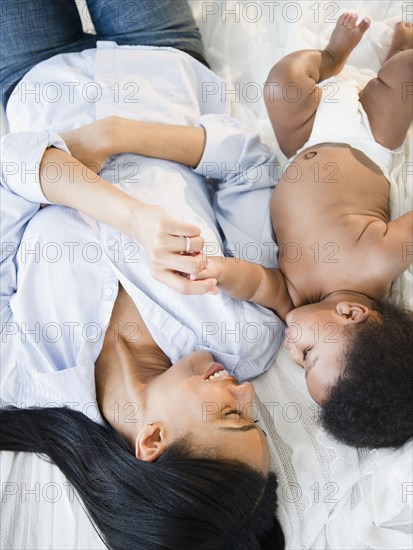 African American mother laying with baby boy