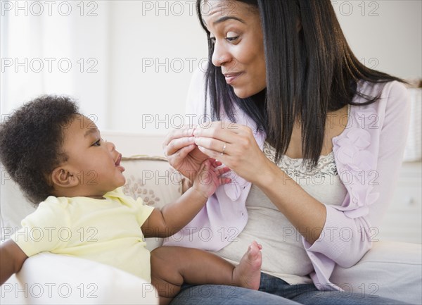 African American mother playing with baby boy