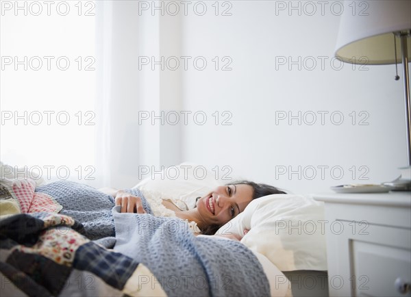 Brazilian woman laying in bed