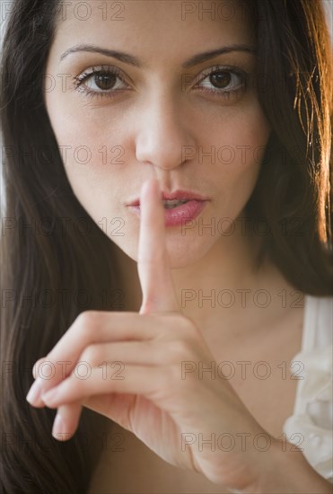 Brazilian woman making shhh gesture