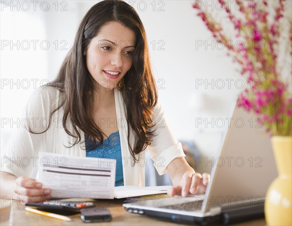 Brazilian woman paying bills online