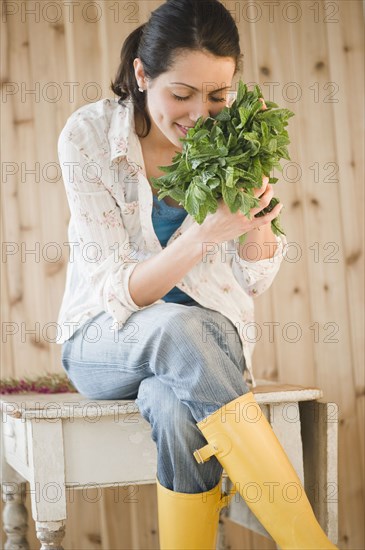 Brazilian woman smelling fresh mint