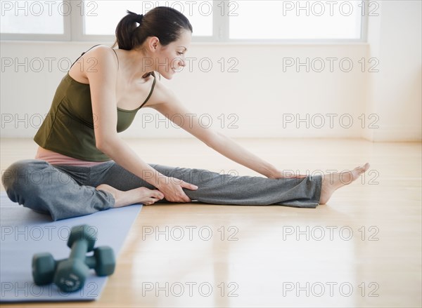 Brazilian woman stretching before exercise