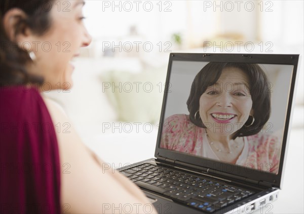Mother and daughter talking over video chat