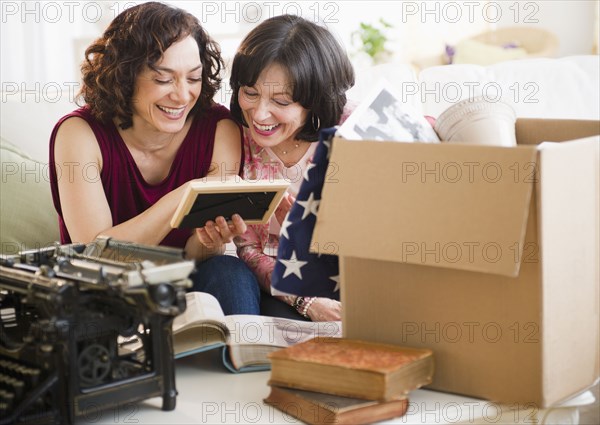 Mother and daughter looking at photograph