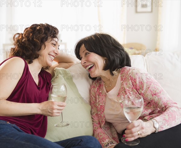 Mother and daughter drinking wine together