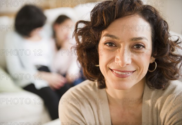 Smiling woman with family in background