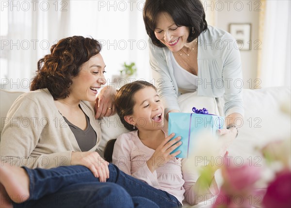 Grandmother giving granddaughter birthday gift