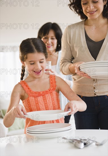 Family setting the table together