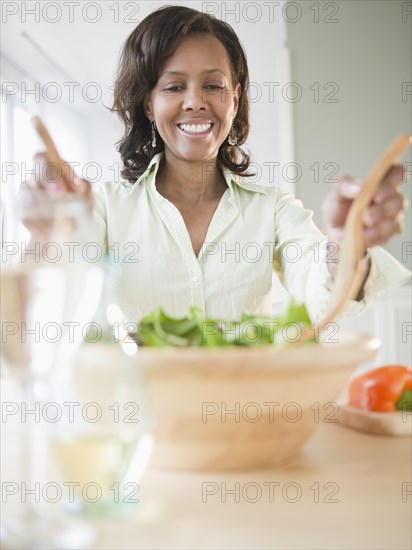 Black woman tossing salad