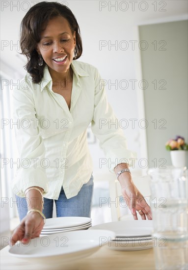 Black woman setting table