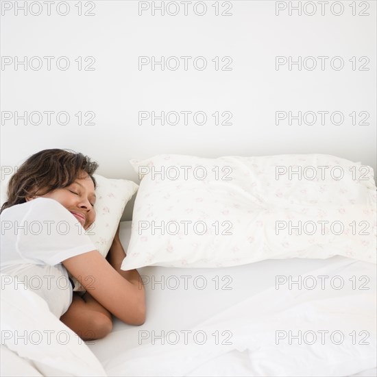 Black woman sleeping in bed