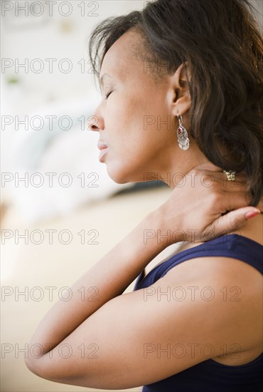 Black woman rubbing her neck