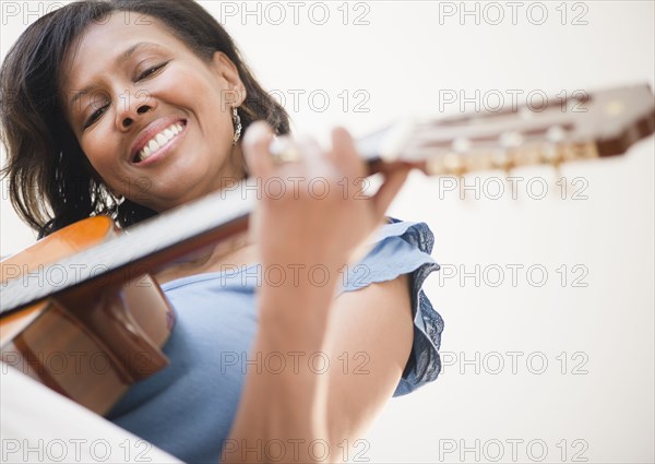 Black woman playing guitar