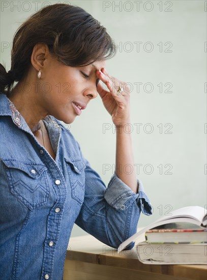 Black teacher in classroom with headache