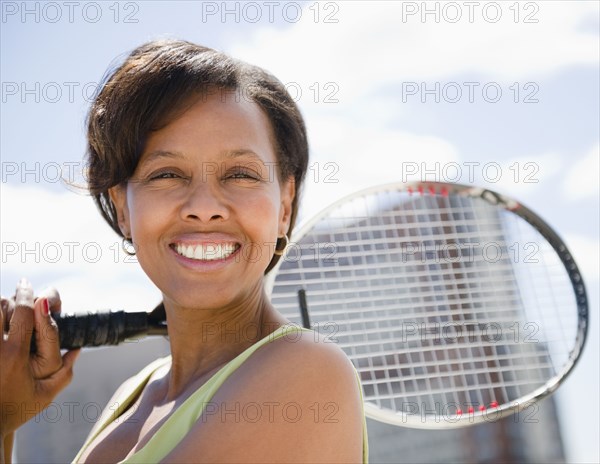 Black woman holding tennis racquet