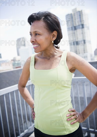 Black woman on urban balcony