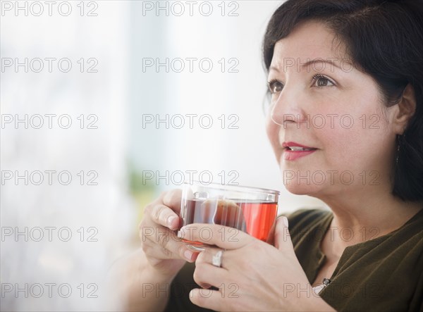 Hispanic woman drinking tea