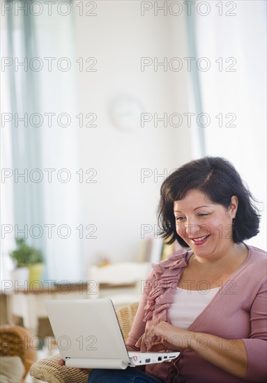 Hispanic woman using laptop