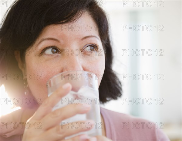 Hispanic woman drinking water